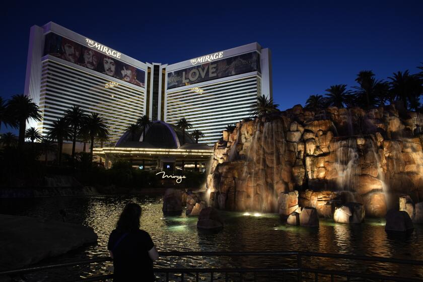 A person stands in front of the Mirage hotel-casino along the Las Vegas Strip Thursday, May 16, 2024, in Las Vegas. 