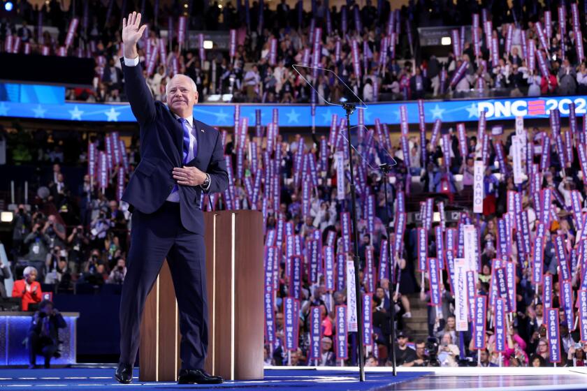 DNC CHICAGO, IL AUGUST 21, 2024 - Democratic vice presidential nominee Minnesota Gov. Tim Walz waves during the Democratic National Convention Wednesday, Aug. 21, 2024, in Chicago. (Robert Gauthier/Los Angeles Times)