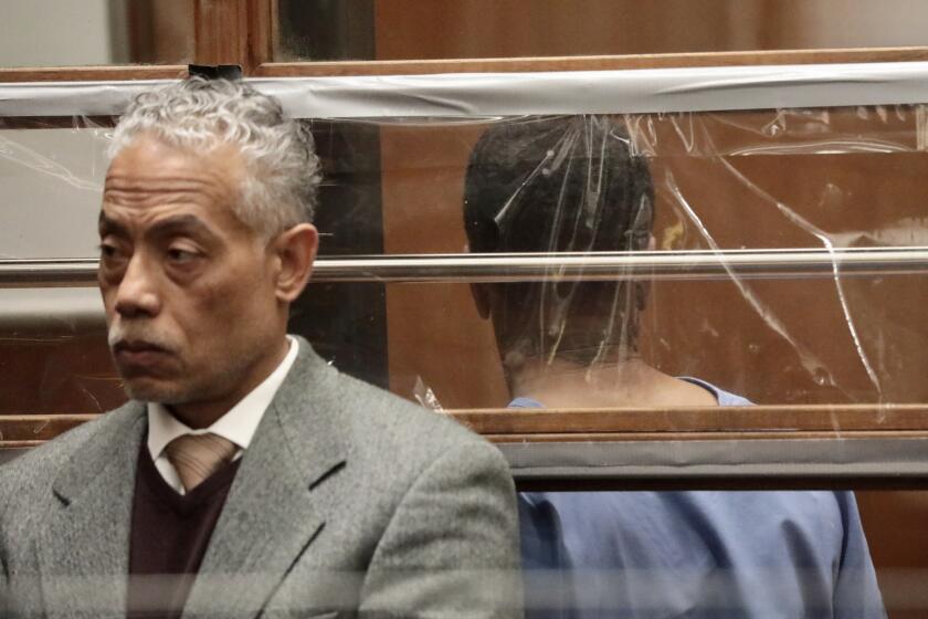 LOS ANGELES CA APRIL 23, 2024 - Ephraim Hunter, right, the suspect in the break-in at Mayor Karen Bass' home, appears in Los Angeles Superior Court for arraignment with Public Defender Carlos Bido, left, late Tuesday afternoon, April 23, 2024. (Al Seib / For The Times)