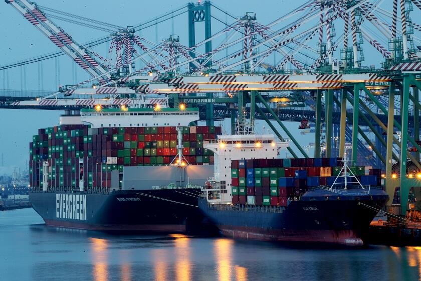 LOS ANGELES, CALIF. - NOV. 18, 2021. Container ships discharge cargo on Terminal Island in the Port of Los Angeles on Thursday, Nov. 18, 2021. (Luis Sinco / Los Angeles Times)