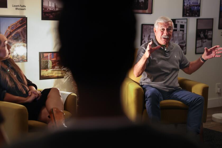 COMPTON-CA-AUGUST 24, 2024: Dr. Albert Camarillo, right, a legendary Chicano Studies scholar and author of Compton in My Soul, a memoir about growing up in Compton during the 1950s and 1960s, speaks to a group of young adults at Color Compton on August 24, 2024. (Christina House / Los Angeles Times)