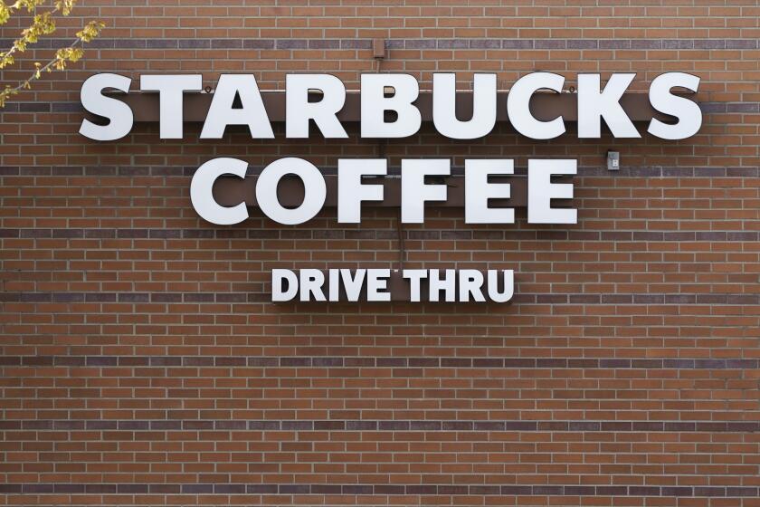 A Starbucks coffee shop logo is seen in the drive thru lane, Tuesday, April 27, 2021, in Des Moines, Iowa. (AP Photo/Charlie Neibergall)