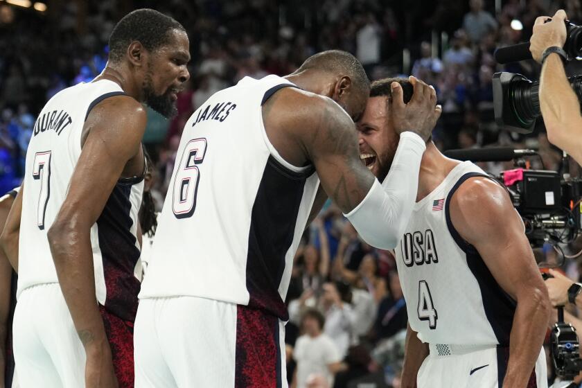 Stephen Curry, right, celebrates with LeBron James, center, and Kevin Durant after the U.S. basketball team beats Serbia