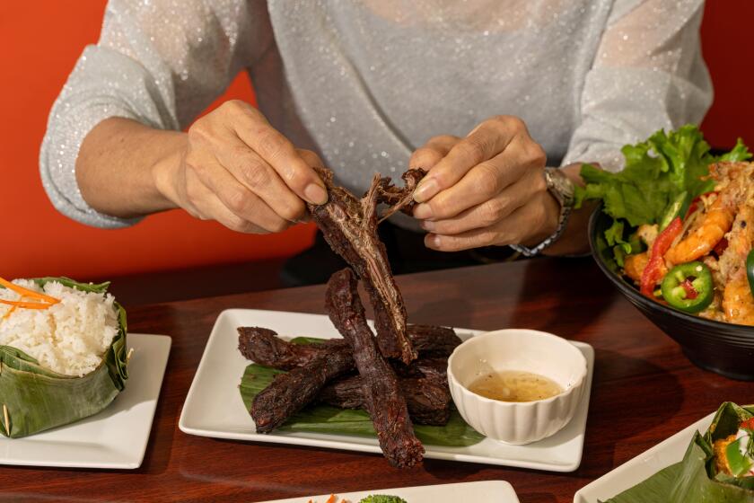 LONG BEACH, CA - MARCH 11: Chef Sophy Khut tears into Beef Jerky at Sophy's: Cambodia Town Food & Music, on Monday March 11, 2024 in Long Beach CA. (Ron De Angelis / For The Times)