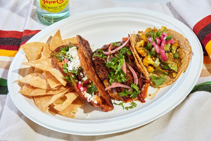 LOS ANGELES, CA - MAY 20 2023: A Taco Combo plate from Saucy Chick / The Goat Mafia in Los Angeles, CA. From Left to right is the Rotisserie Taco, a Birria Taco, and a Charred Haldi Cauliflower Taco. (Oscar Mendoza/LA Times)