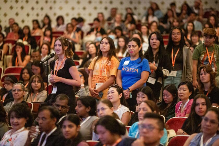 Pasadena, CA - August 08: Participants wait in line to question in a lecture by scientist Dr. Katie Bouman, who developed the first algorithm to capture images of black holes, at Beckman Auditorium during the annual Women in Stem program at California Institute of Technology Thursday, Aug. 8, 2024 in Pasadena, CA. (Ringo Chiu / For The Los Angeles Times)