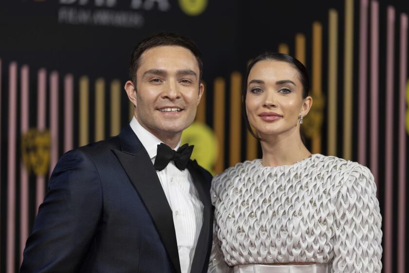 Ed Westwick and Amy Jackson pose together at an awards show