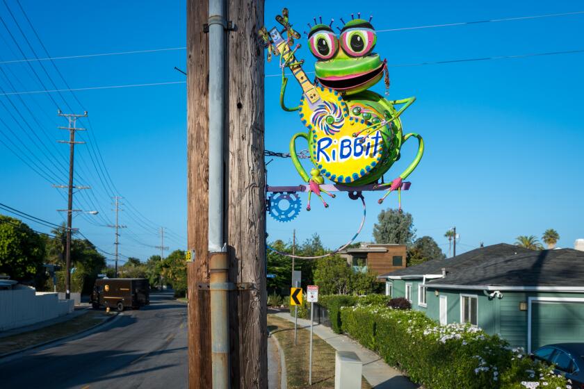 MAR VISTA, CA - Aug. 13, 2024: Sculptures by artist Lori Powers that are affixed to utility poles on Palms Boulevard in Mar Vista. (Michael Owen Baker / For The Times)