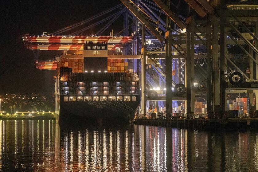 FILE - The Container ship Cam Cgm Arctic (MT) is moored at Maersk APM Terminals Pacific, Pier 400, at the Port of Los Angeles on Monday, Nov. 21, 2022. On Thursday, the Commerce Department issues its first of three estimates of how the U.S. economy performed in the fourth quarter of 2022. (AP Photo/Damian Dovarganes, File)